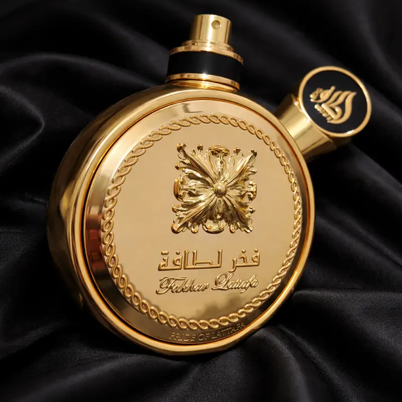 Angled side view of the Lattafa Fakhar Perfume Extrait Gold bottle reflecting light on its surface.