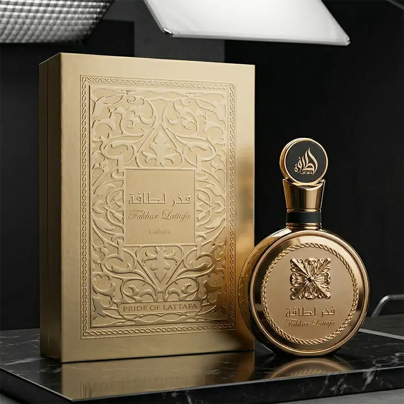 Display set featuring both the Lattafa Fakhar Perfume Extrait Gold bottle and its decorative box.