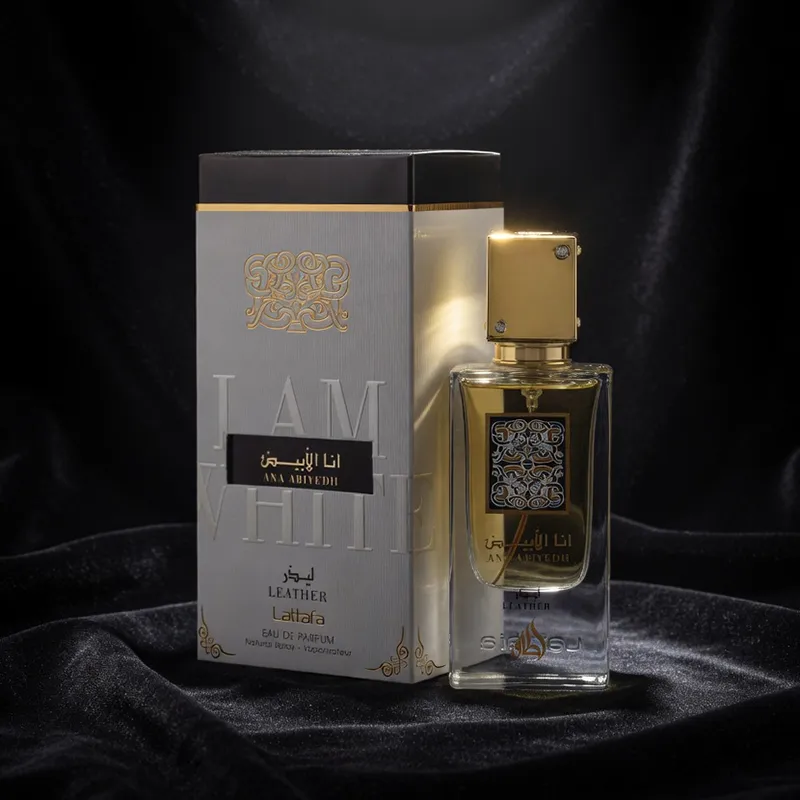 Lattafa Ana Abiyedh Leather unisex EDP bottle and packaging dramatically spotlighted on black velvet.