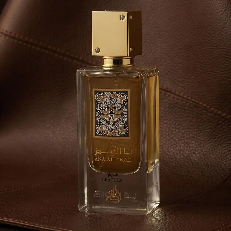 Lattafa Ana Abiyedh Leather unisex EDP 60ml bottle resting contextually on a brown leather surface.