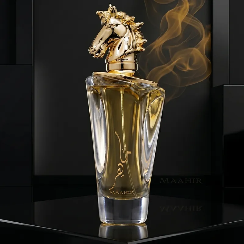 Close-up of Lattafa Maahir unisex perfume bottle featuring the artistic gold horse head cap and amber floral liquid.