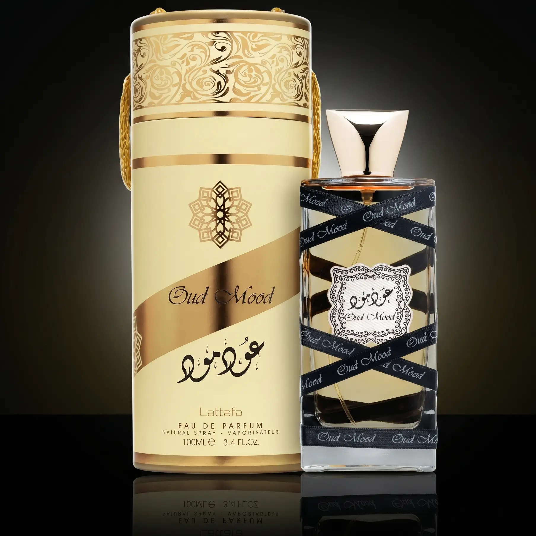Lattafa Oud Mood unisex perfume bottle and gold cylinder packaging box hero image.